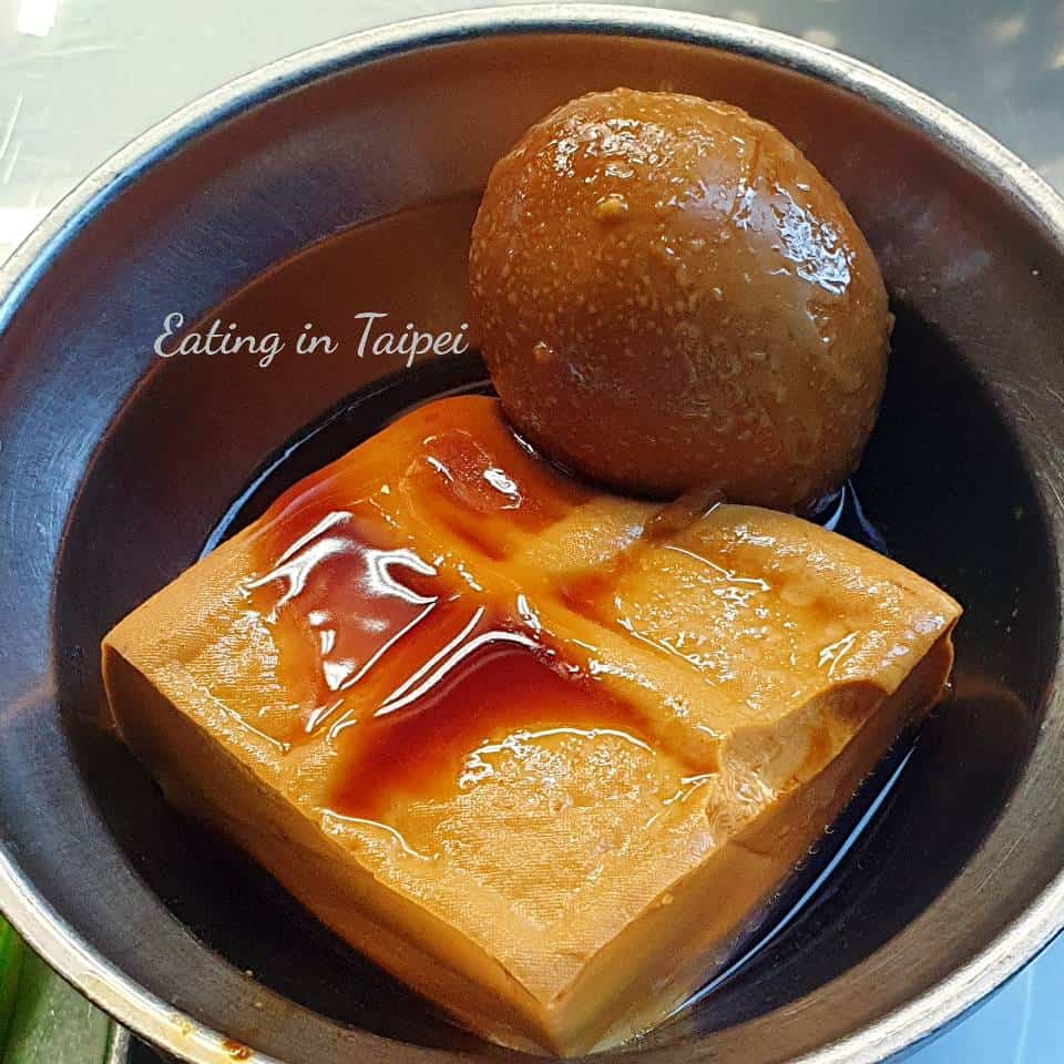 The egg and tofu are also served in a metal bowl, doused in sauce